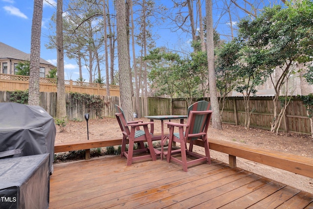 wooden deck featuring grilling area and a fenced backyard