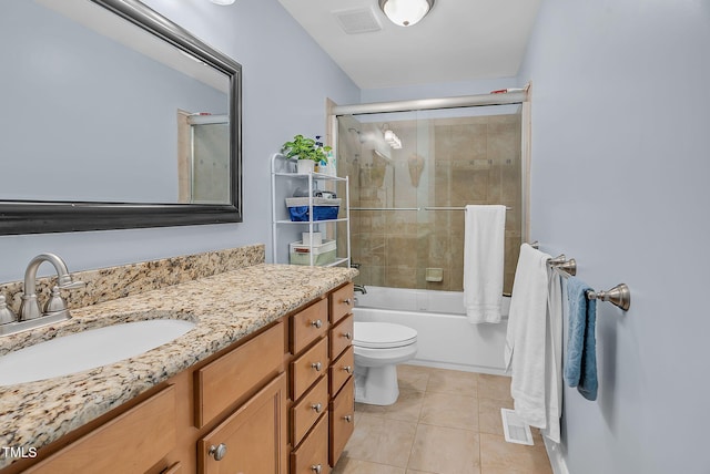 bathroom with toilet, tile patterned flooring, visible vents, and bath / shower combo with glass door