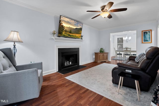 living area with baseboards, a fireplace with flush hearth, ornamental molding, and wood finished floors