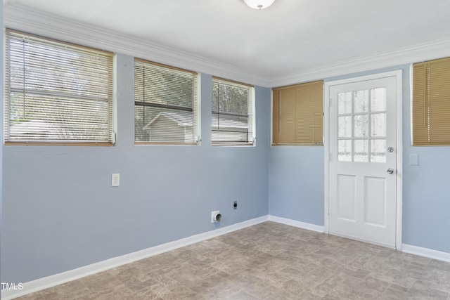 empty room featuring plenty of natural light and baseboards