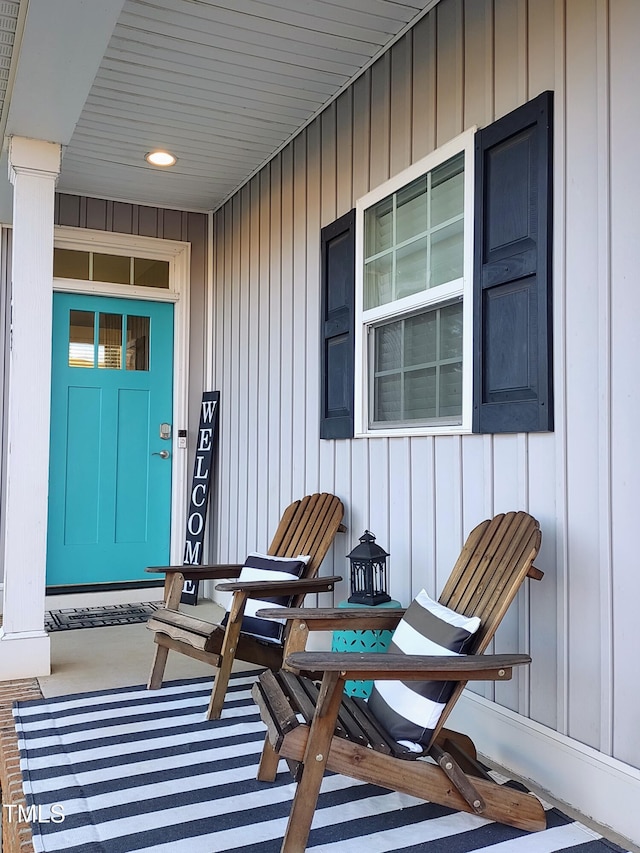 doorway to property with a porch and board and batten siding