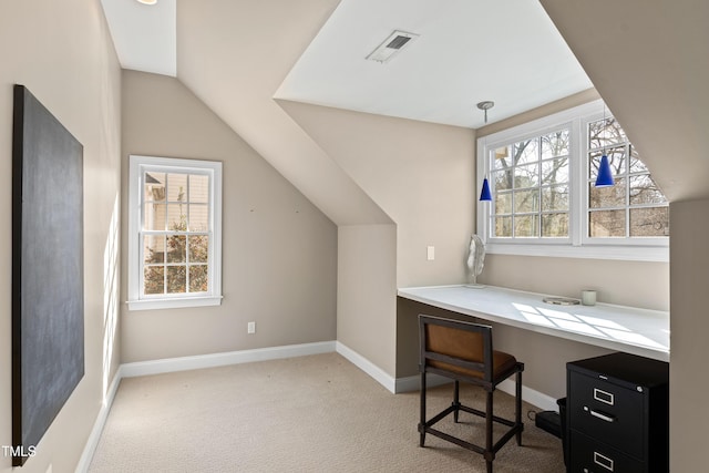 home office featuring carpet, vaulted ceiling, plenty of natural light, and visible vents