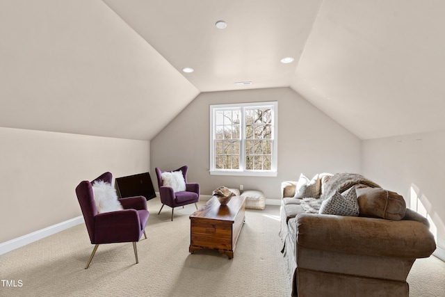 sitting room with vaulted ceiling, carpet floors, visible vents, and baseboards