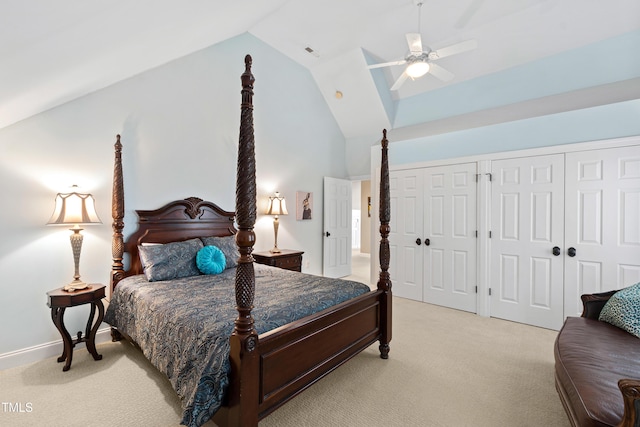 bedroom with a ceiling fan, light colored carpet, visible vents, and two closets