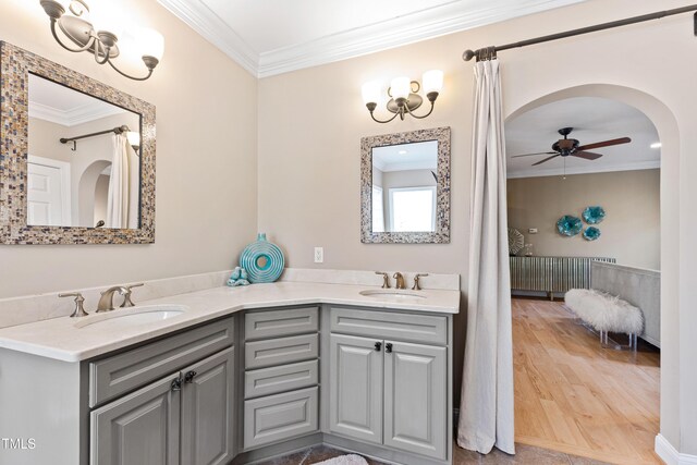 full bathroom featuring ornamental molding, a sink, and wood finished floors