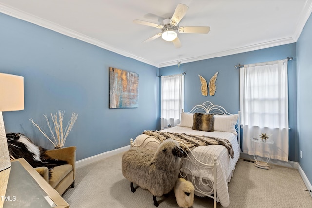 bedroom featuring carpet floors, crown molding, baseboards, and a ceiling fan