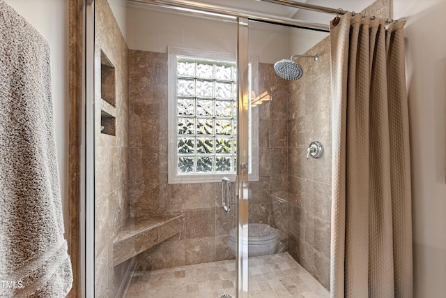 full bath featuring plenty of natural light and a shower stall