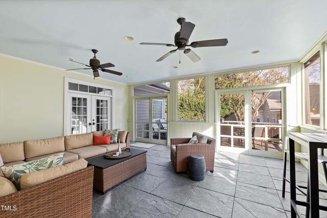 sunroom with a ceiling fan and french doors