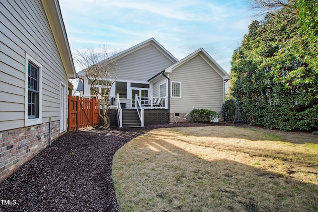 exterior space with a yard, crawl space, and fence