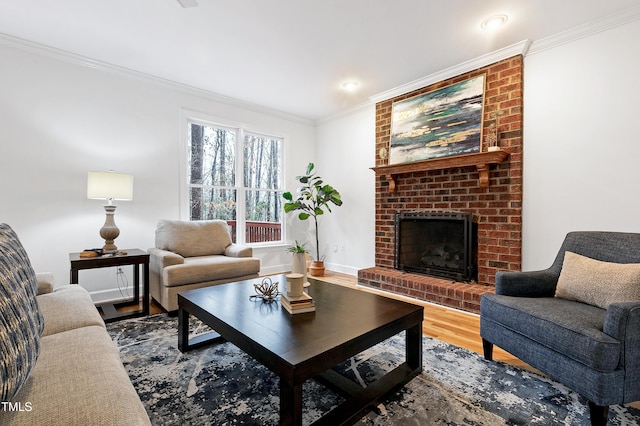 living room with a brick fireplace, baseboards, ornamental molding, and wood finished floors