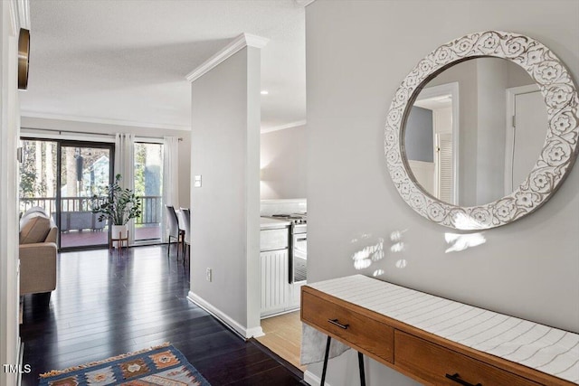 corridor featuring crown molding, baseboards, and hardwood / wood-style floors