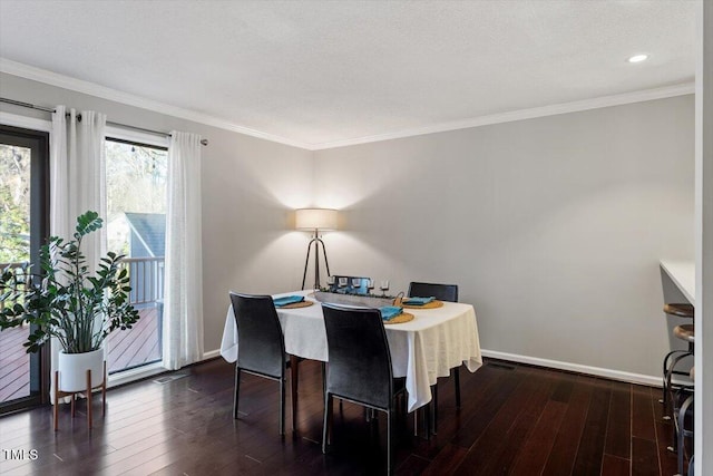 dining space with crown molding, baseboards, and dark wood-type flooring