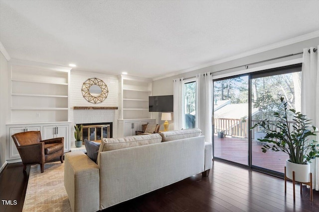 living area with crown molding, wood-type flooring, and a healthy amount of sunlight