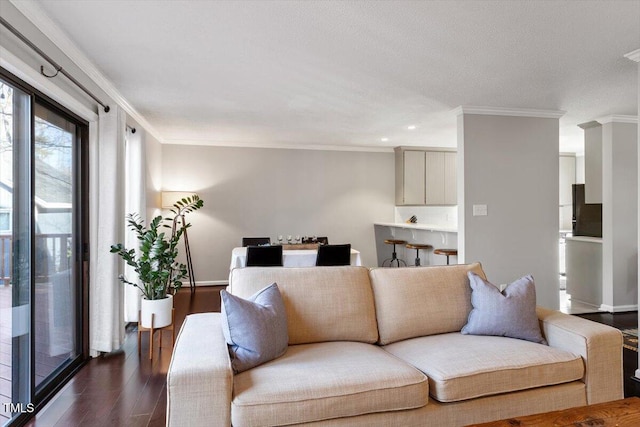 living room featuring baseboards, dark wood-style flooring, and crown molding