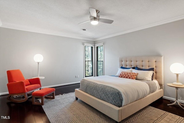 bedroom with a textured ceiling, wood-type flooring, baseboards, and crown molding