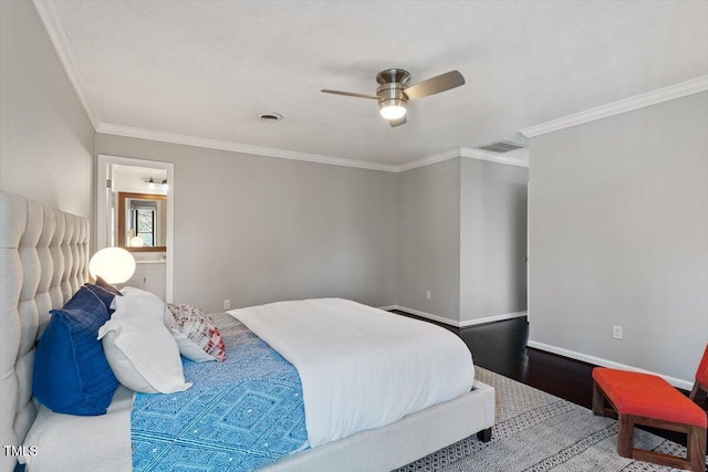 bedroom featuring baseboards, visible vents, wood finished floors, and ornamental molding