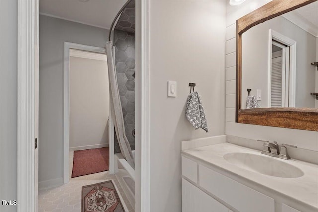 bathroom featuring shower / tub combo, vanity, and baseboards