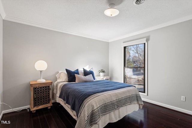 bedroom with crown molding, a textured ceiling, baseboards, and hardwood / wood-style floors