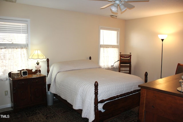 bedroom featuring multiple windows and a ceiling fan