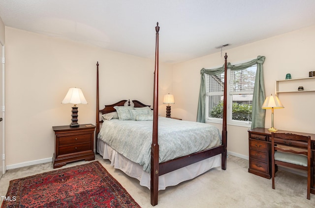 bedroom with visible vents, light carpet, and baseboards