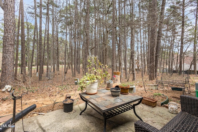 view of patio / terrace featuring an outdoor fire pit