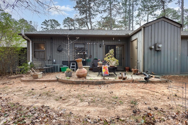 back of house featuring board and batten siding and a patio area