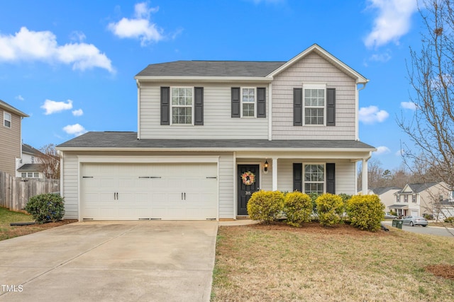 traditional home with a porch, a garage, fence, concrete driveway, and a front lawn