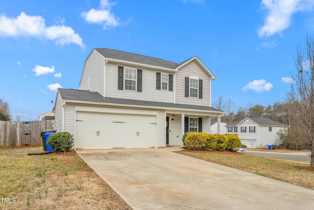 traditional-style home with a garage, concrete driveway, a front lawn, and fence