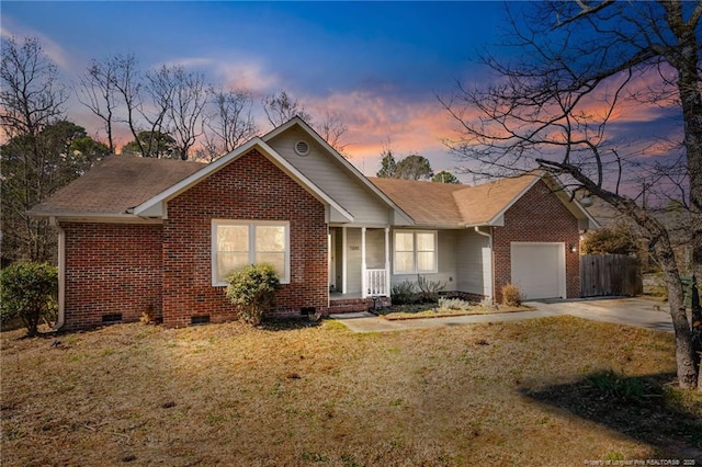 ranch-style house featuring a garage, brick siding, driveway, crawl space, and a front yard