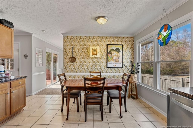 dining area with ornamental molding, a textured ceiling, baseboards, and light tile patterned floors