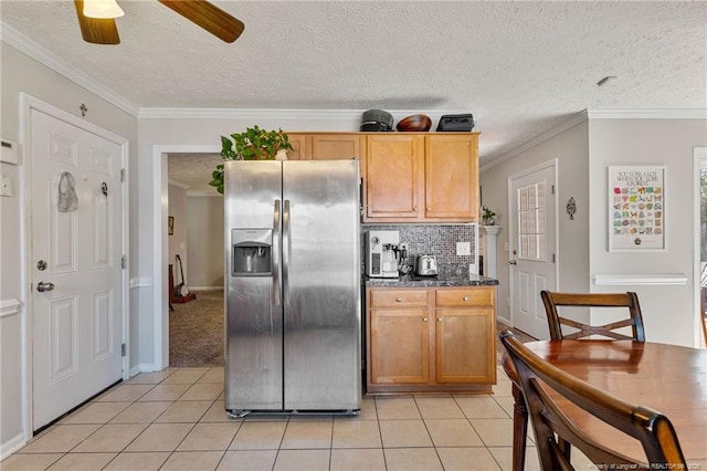 kitchen featuring crown molding, light tile patterned floors, decorative backsplash, a ceiling fan, and stainless steel fridge with ice dispenser