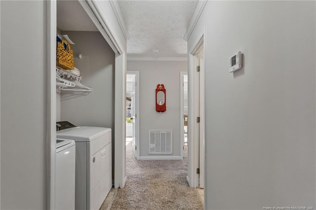 washroom featuring washer and clothes dryer, visible vents, light carpet, a textured ceiling, and laundry area