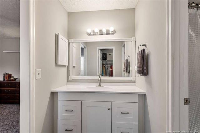 bathroom with vanity and a textured ceiling