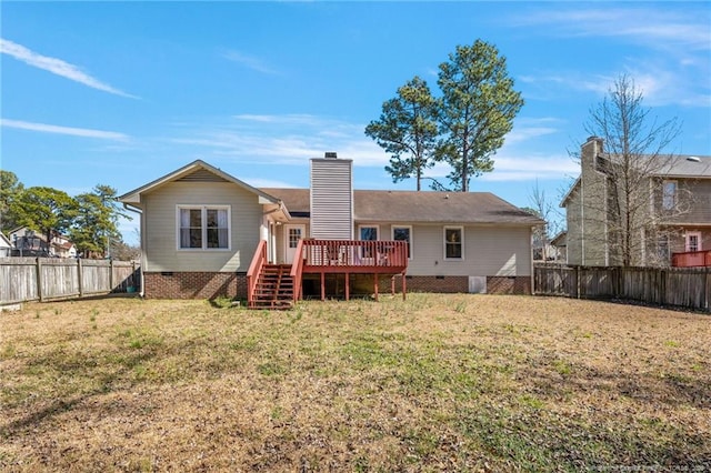 back of house featuring a yard, a chimney, crawl space, a deck, and a fenced backyard