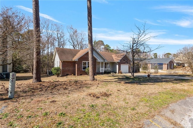 view of side of home with a garage and brick siding