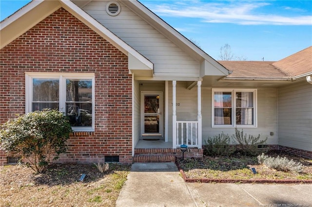 property entrance with brick siding and crawl space