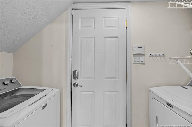 washroom featuring laundry area, independent washer and dryer, and a textured ceiling