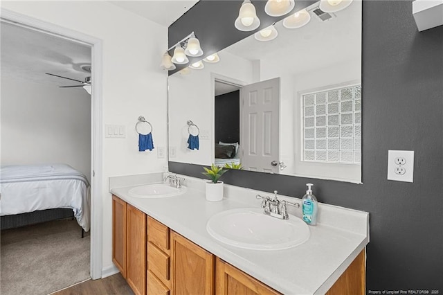 bathroom with double vanity, a sink, and ensuite bathroom