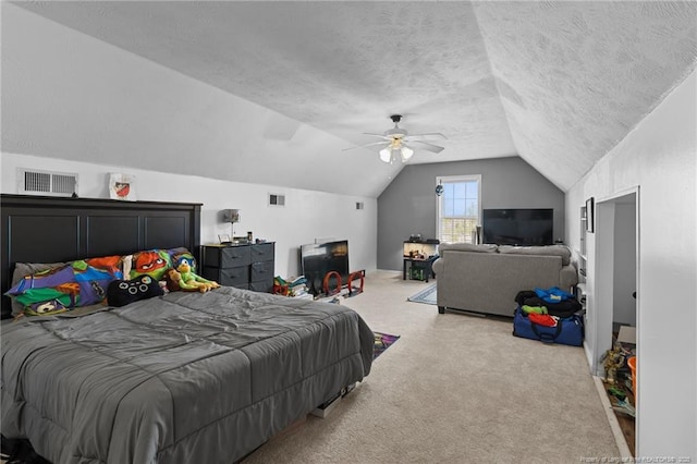 bedroom with lofted ceiling, a textured ceiling, carpet, and visible vents