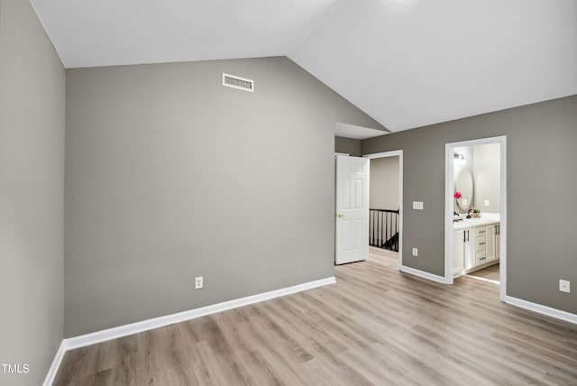 131 Cricketgrass Dr, Cary, NC 27513 - unfurnished bedroom featuring light wood-type flooring, vaulted ceiling, baseboards, and ensuite bathroom