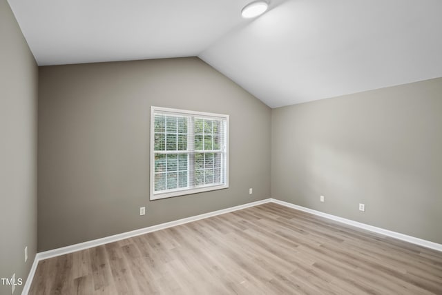 131 Cricketgrass Dr, Cary, NC 27513 - spare room featuring light wood-style floors, vaulted ceiling, and baseboards