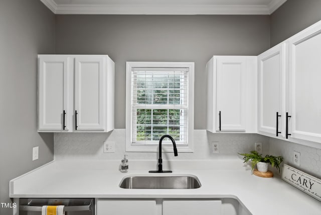 131 Cricketgrass Dr, Cary, NC 27513 - kitchen featuring a sink, light countertops, white cabinetry, crown molding, and tasteful backsplash