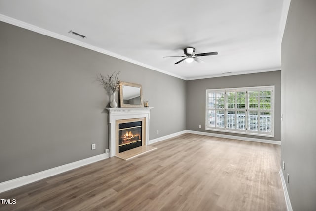 131 Cricketgrass Dr, Cary, NC 27513 - unfurnished living room featuring ceiling fan, wood finished floors, a glass covered fireplace, crown molding, and baseboards