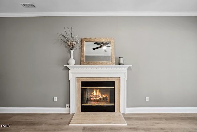 131 Cricketgrass Dr, Cary, NC 27513 - detailed view of wood finished floors, a glass covered fireplace, baseboards, ornamental molding, and ceiling fan