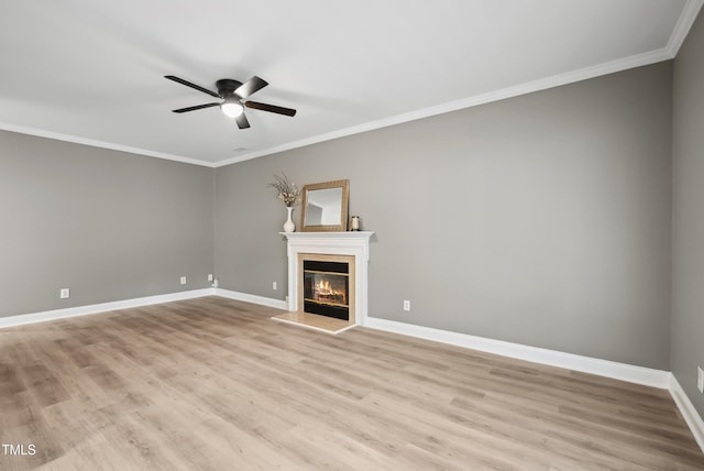 131 Cricketgrass Dr, Cary, NC 27513 - unfurnished living room featuring ceiling fan, ornamental molding, light wood-type flooring, a glass covered fireplace, and baseboards