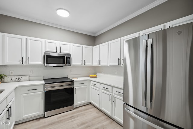 131 Cricketgrass Dr, Cary, NC 27513 - kitchen featuring appliances with stainless steel finishes, crown molding, white cabinetry, light countertops, and light wood-style floors