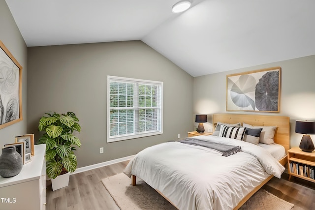 131 Cricketgrass Dr, Cary, NC 27513 - bedroom featuring light wood-type flooring and vaulted ceiling
