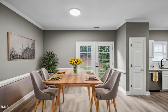 131 Cricketgrass Dr, Cary, NC 27513 - dining area with light wood finished floors, ornamental molding, french doors, and baseboards
