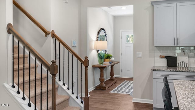 entryway with baseboards and wood finished floors