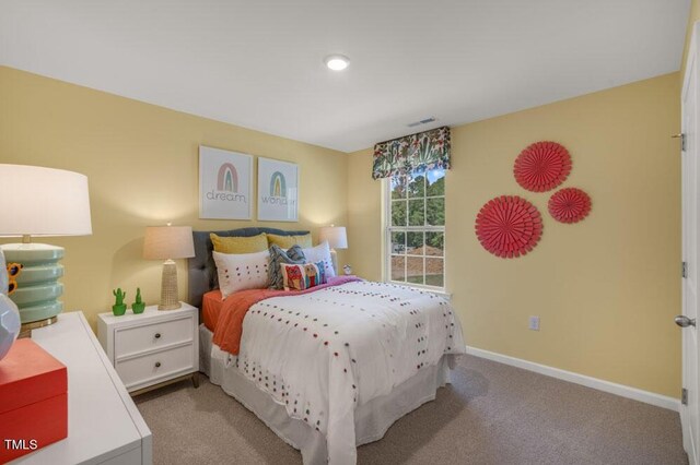 carpeted bedroom featuring visible vents and baseboards